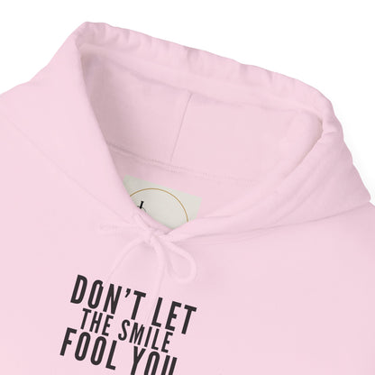 Don't Let the Smile Fool You. Gildan Unisex Hoodie