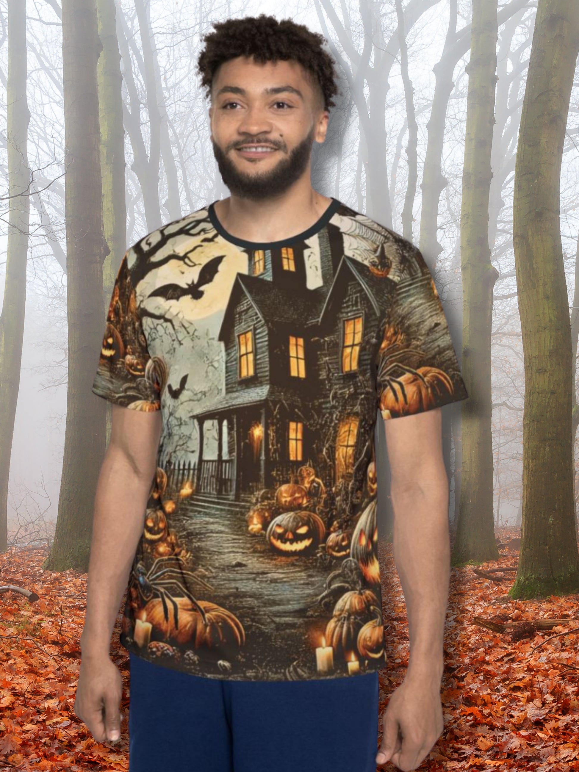 Unisex all-over-print Halloween t-shirt featuring a gothic haunted house design with glowing pumpkins, bats, and eerie forest details. Boutique horror fashion with spooky seasonal vibes.