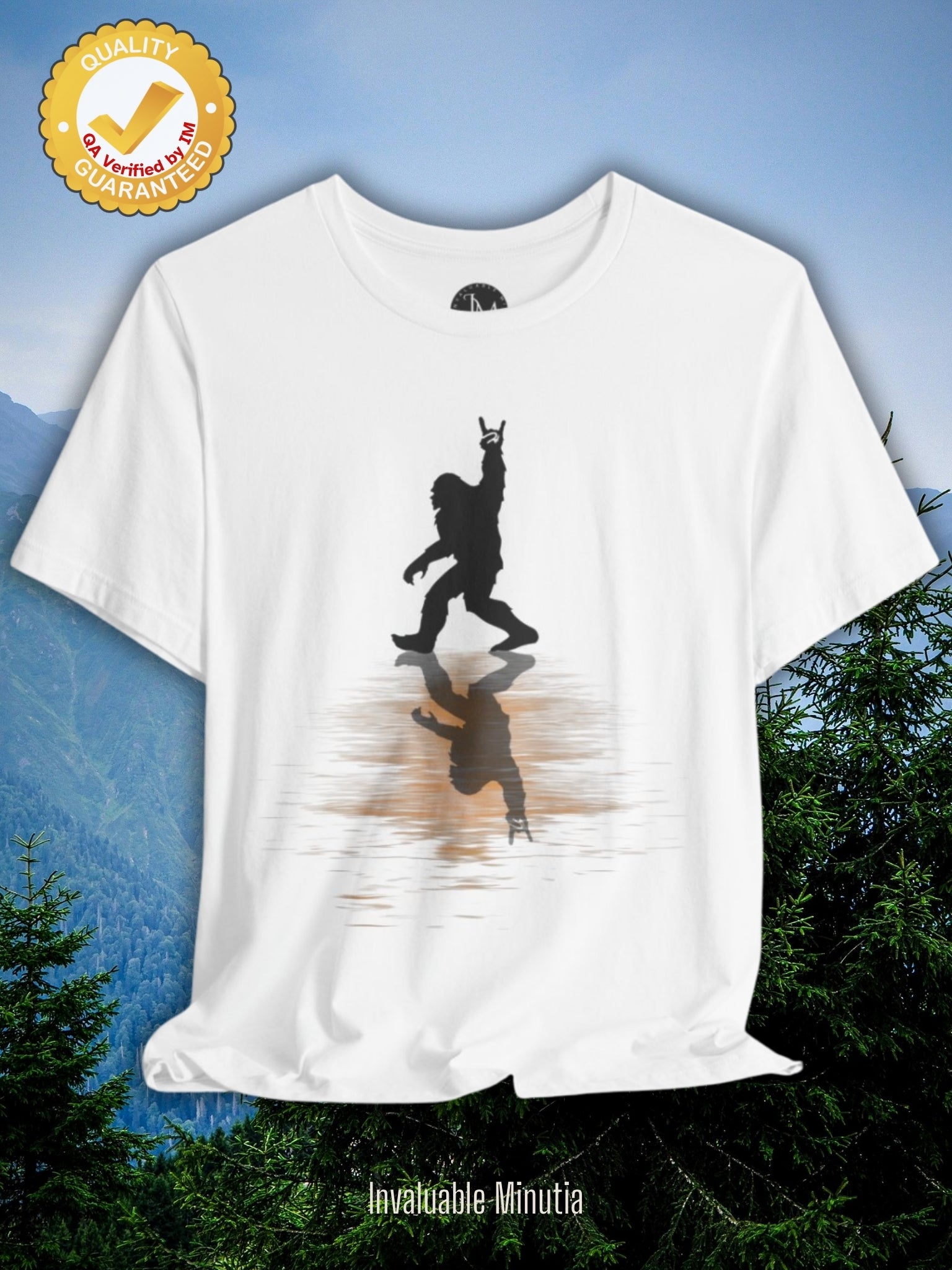 Rocking Bigfoot Unisex Bella+Canvas Jersey Tee – fun white graphic shirt featuring a Bigfoot silhouette throwing the rock hand sign with water reflection. Premium Bella+Canvas quality tee by Invaluable Minutia, perfect for nature fans, cryptid lovers, and quirky style seekers.
