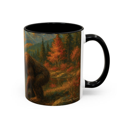 Right-side product view of 11oz Bigfoot River Scene ceramic coffee mug with black accent handle and interior — detailed wilderness artwork featuring Bigfoot near a river surrounded by autumn trees and mountain peaks. Premium ceramic accent mug by Invaluable Minutia. InvaluableMinutia.com