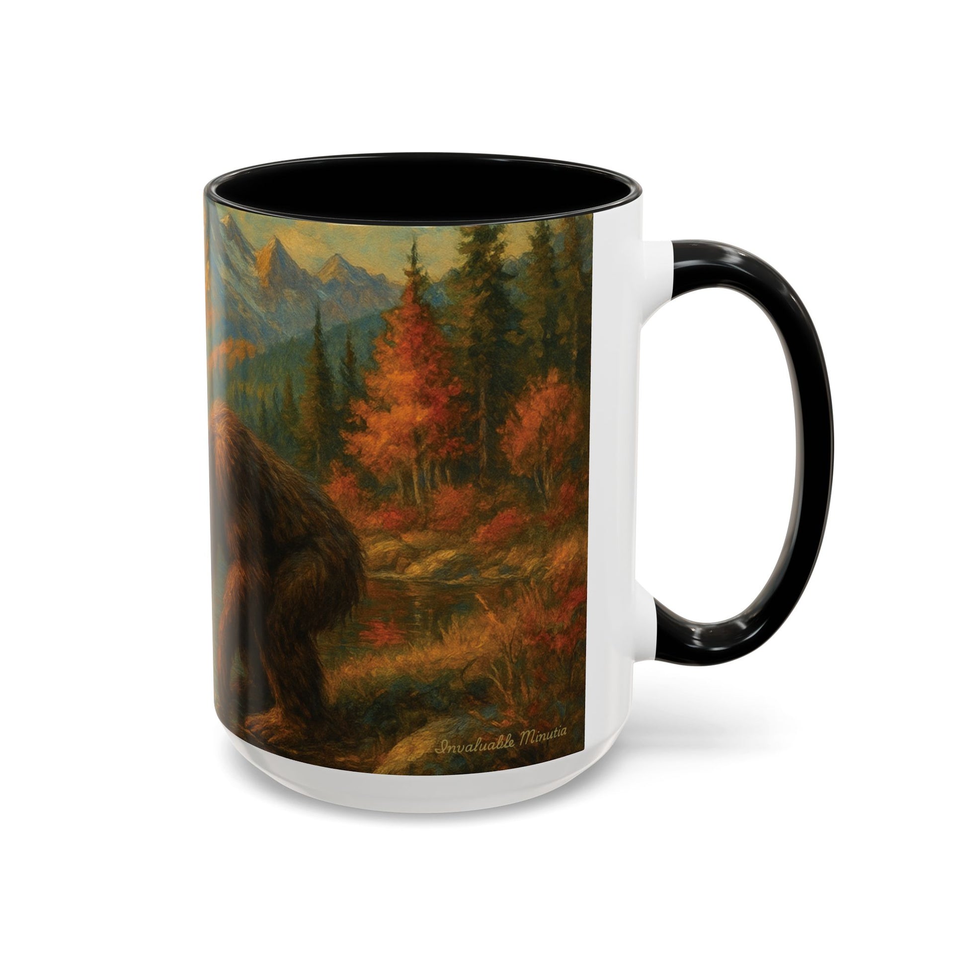 Right-side view of 15oz Bigfoot River Scene ceramic coffee mug with black accent handle and interior — detailed artwork of Bigfoot standing beside a mountain river surrounded by autumn forest and golden peaks. Oversized premium mug by Invaluable Minutia. InvaluableMinutia.com